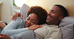 Happy, relax and black couple on bed in home for bonding, love and care in marriage on weekend. Smile, kiss and man with woman in bedroom for connection, calm or peaceful morning together in house.