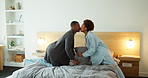 Couple, kiss and cleaning bedroom in house with pillow, blanket and fresh linen in morning. Happy man, black woman and tidy bed in home with support, playful and together for chores in pyjamas