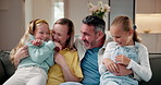 Tickle, girls and smile with parents in home for care, support or connection together on sofa. Children, daughters and embrace with people in living room for family bonding, love and funny joke