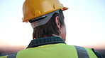 Back, thinking and engineer outdoor with helmet, inspection and planning for architecture. Thoughts, man or reflection with ppe for construction, urban view and quality assurance for building project
