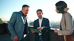 City, meeting and business people on balcony with tablet, real estate agent and property investment. Realtor, team and talk outdoor with tech for urban development idea, planning and collaboration.