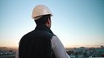 Thinking, engineer and helmet outdoor for construction, inspection or planning for architecture. Back, man and hardhat on balcony for reflection, urban view and quality assurance for building project