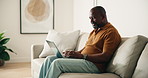 Man, typing and remote work in home with laptop, email or marketing manager smile for digital campaign. Mature, black person or freelancer in house with computer, editing creative project or proposal