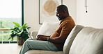 Man, typing and remote work in living room with laptop, email or marketing manager for digital campaign. Mature, black person and freelancer in home with computer, editing ad project and proposal.