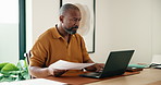 Documents, laptop and remote work with black man in home office for report, research or review. Computer, paperwork and planning with mature person in apartment for feedback as freelance employee