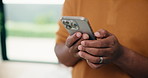 Man, hands and typing with phone in home for network connection, social media or communication. Male person, texting or chatting with mobile smartphone for online app, browsing or internet service