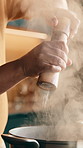 Man, hands and season with salt in pot for recipe, culinary art or meal preparation in home. Male person, chef or added flavor with spice or ingredients for taste, smell or hospitality skill in house
