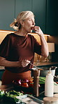 Woman, taste or cooking with pot in kitchen for healthy recipe, ingredient or flavor in home. Mature, female person or chef with vegetables, spice or seasoning for culinary art or food prep in house