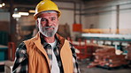 Carpentry, hardhat or man in warehouse with face, hazard protection or pride as timber craftsman. Happy, helmet or mature artisan with confidence, compliance or ppe gear in woodworking industry.