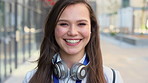 Face, businesswoman and commute in city with smile, headphones and experience for marketing career. Happy, female person and audio tech downtown with pride, good mood and travel for advertising job.