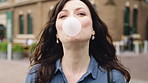 Bubblegum, travel and face of woman in city for smile, summer vacation and laughing. Chewing gum, funny joke and holiday adventure with portrait of person outdoor for candy, weekend break and peace