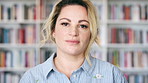 Woman, face and entrepreneur at bookstore with shelf, confidence and pride with literature at shop. Person, small business owner and portrait with career, knowledge or information in New Zealand