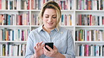Teacher, research or happy woman with phone in library for academic study, knowledge or information. Female person, professor or scrolling with smile on smartphone for online curriculum or syllabus