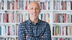 Publisher, laugh and face of man with crossed arms for career, opportunity and managing editor. Creative, happy and portrait of person by bookshelf for publicist, about us or job at publication house