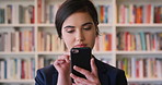 College, student or woman in library with phone, scroll social media or email for business course. Person, reading or browsing at university campus with tech, text message or commerce faculty website