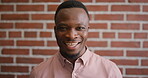Confident, face and businessman with smile, brick wall and creative for marketing career development. Business, brand manager and black person with pride for opportunity, happy and ambition in Kenya
