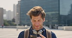 Man, student or phone with backpack in city for class schedule, outdoor network or communication. Male person, academic learner or scrolling with smartphone for learning period or checking curriculum
