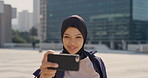 Selfie, city and muslim girl with hijab for photography, outdoor memory or social media post. Female person, student or islamic learner with smile for capture moment, picture or app in an urban town