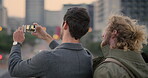 Business, photo or friends in city with phone screen, outdoor post or selfie capture on work commute. Back, people or employees with tech, online memories or cityscape picture with urban travel.