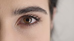 Woman, health and eye closeup with face for optometry test, optical vision and ocular wellness. Eyesight examination, contact lenses and eyecare assessment with person in studio on white background
