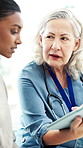 Appointment, women and doctor with tablet in clinic for medical diagnosis, discussion or explain. Help, people and mature healthcare worker with tech for patient records, treatment and advice