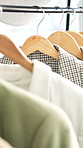 Rail, hangers and blazers in store for fashion with choice, decision or shopping in mall. Discount rack, sale and jackets with luxury brand for stylish outfit with clothing option in boutique.