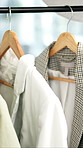 Rail, hangers and jackets in store for fashion with choice, decision or shopping in mall. Discount rack, sale and blazers with luxury brand for stylish outfit with clothing option in boutique.