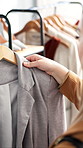 Rail, hanger and woman with blazer for fashion with choice, decision or shopping in store. Discount rack, sale and female person with jacket for luxury brand, outfit or clothing option in boutique.