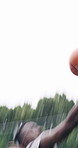 Men, sport and motion with basketball on court for competition, outdoor match or game together. Active, male people or athletic players with ball, dribble or offense for tournament on wet pitch