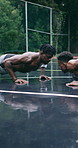 Men, training and push ups with exercise on basketball court for sports drill, activity or workout. Active, male people or athletic players getting ready with team on wet floor or pitch for game