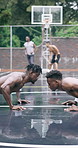 Men, practice and push ups with exercise on basketball court for sports drill, activity or workout. Active, male people or athletic players getting ready with team on wet pitch for game or training