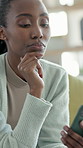 Reading, thinking and black woman with phone on couch, message reflection and response idea for chat. Texting, home and person with mobile for digital communication, social media and planning answer