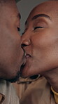 Love, smile or couple in cafe with kiss, partnership and bonding together in connection. Comfort, happy or black people in bistro with affection, romantic moment or commitment in healthy relationship