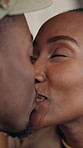 Love, happy or couple in cafe with kiss, partnership or bonding together in connection. Smile, security or black people in bistro with affection, romantic moment or commitment in healthy relationship