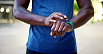 Hand, smartwatch and tracker for workout, fitness or heart rate in city with performance progress. Athlete, person and typing with digital tech for monitoring exercise, runner and wellness results