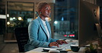 Black woman, computer and typing in office at night for research, finance chat and schedule update. African person, tech and communication for financial feedback, funding or offer for overtime