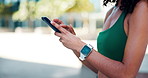 Phone, athlete and hands of woman in city with typing for texting, social media or chatting. Fitness, technology and female person scrolling on app for workout program on cellphone in urban town.