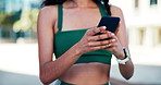Cellphone, fitness and hands of woman in city with typing for texting, social media or chatting. Athlete, technology and female person scrolling on app for workout program on phone in urban town.