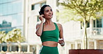 Earphones, sports and woman in city with music, podcast or playlist for runner, exercise or wellness. Audio tech, athlete and female person listening to album or radio for cardio workout in town.