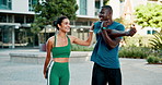 Fitness, interracial couple and stretching in city for warm up, support and together for wellness. Man, woman and smile in urban town for exercise, flexibility and happy for health and development
