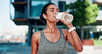 City, woman and fitness break for drinking water, hydration and liquid beverage for workout. Training, female person or rest with bottle for mineral H2O, thirst or wellness for exercise in summer