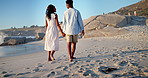 Walking, holding hands and back of couple at beach for holiday, vacation and bonding on weekend. Dating, travel and African man and woman by sea for conversation, relationship and connection for love