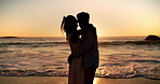 Sunset, beach and black couple with forehead touch for love, bonding and intimate moment. Care, hug and African man with woman for connection, support or trust by ocean for seaside holiday together.