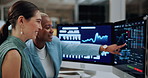 Chart, meeting and business women on computer screen for stock market, trading and investment. Corporate, night and people pointing on pc for financial review, graphs and research for cryptocurrency