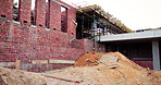 Construction, infrastructure and empty building at site, brick wall and concrete for engineering. Architecture, scaffolding and exterior with incomplete development, soil and framework design