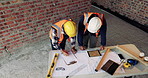 Writing, team or architect with blueprint at construction site, property layout or renovation project. Reading, above or people with maintenance idea for building plan, engineering or remodel review