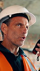 Construction, radio and talking with man on building site for communication, instructions or update. Connection, conversation and explain with mature person on worksite for project management