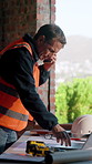Man, architect and phone call with laptop on construction site for building plan or development. Mature, male person or civil engineer talking with smartphone or computer for architecture project