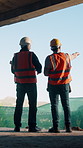 Back, team or people with inspection at construction site, infrastructure planning or assessment. Property evaluation, engineer or men with pointing for building check, development or renovation idea