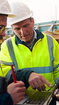 Construction site, team and talk with laptop, meeting and project feedback for building development. Engineer, planning or men outdoor with computer for infrastructure, idea and safety evaluation